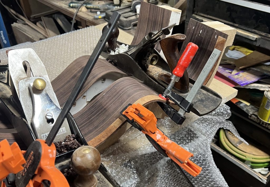 Pre-bent lining clamped to body until cool.